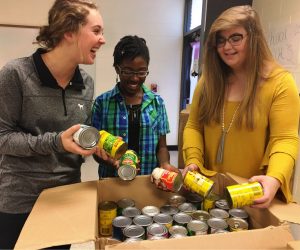 East Coweta High School Student Government members organize their school’s Can-A-Thon drive.  The high school raised the most food and cash donation – the equivalent of 17,000 items – of all Coweta schools.